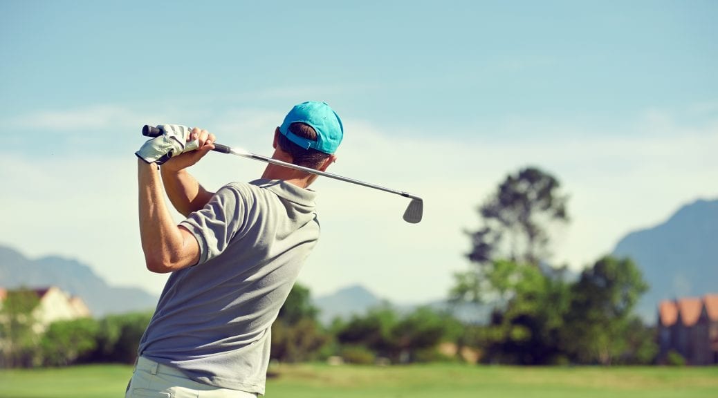Shoulder pain while golfing; Golfer hitting golf shot with club on course while on summer vacation