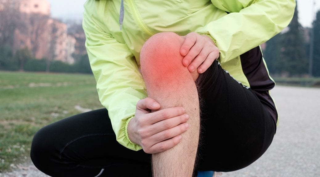 Runner with injured ankle while training in the city park in cold weather; blog: Tips for Relieving Joint Pain in Winter
