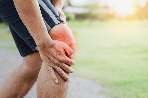 A man with an injured knee: one of the top Sports-Related Orthopedic Injuries